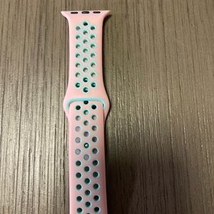 Pink Apple Watch sports band with breathable air holes.